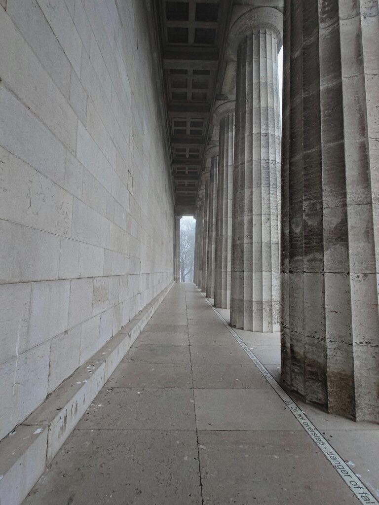 A row of strong, classical stone pillars representing the solid inner foundation needed for personal development